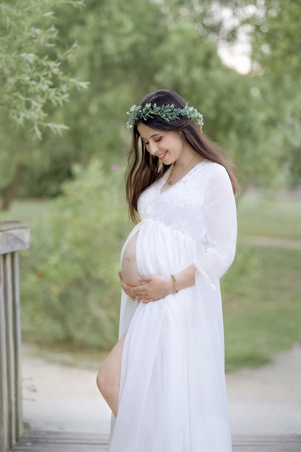 Photo d'une femme enceinte en plein nature regardant son ventre au lac de Bruguières